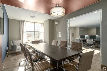A conference room with a long table and chairs.