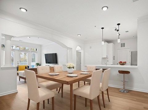 A dining room with a wooden table and chairs.