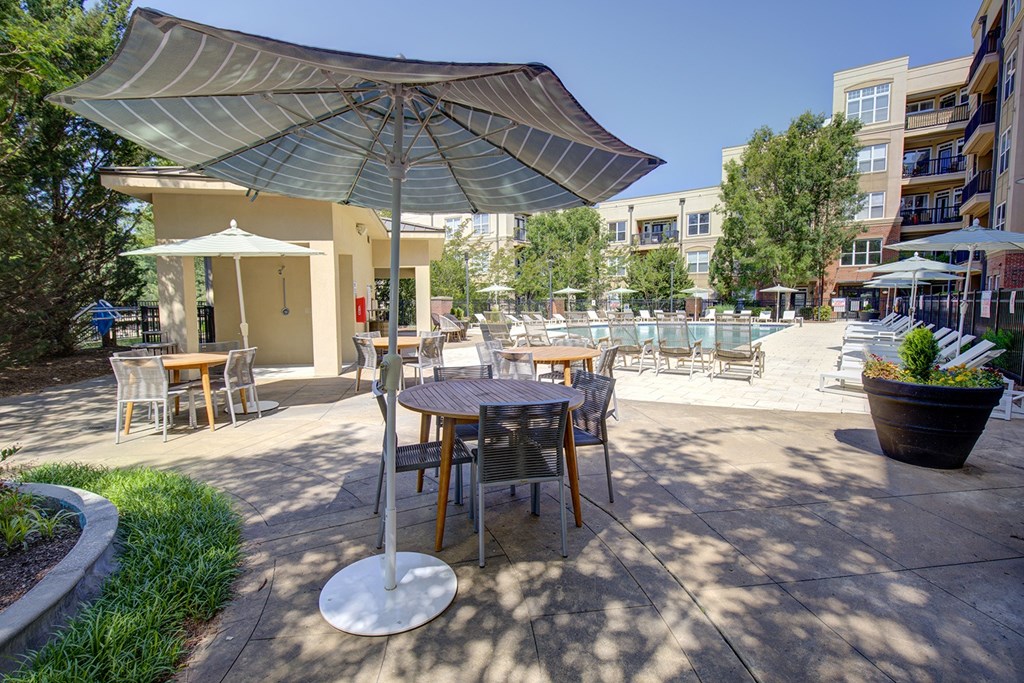 A patio with a table and chairs under a canopy.