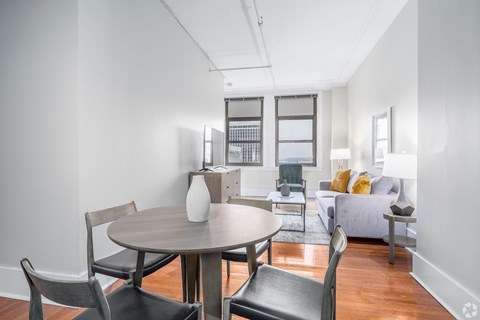A modern dining room with a round table and chairs.