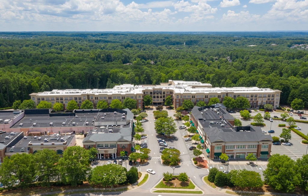 A large building complex with a parking lot in front.
