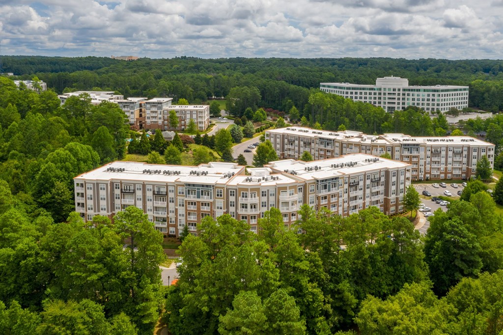A large building complex surrounded by trees.