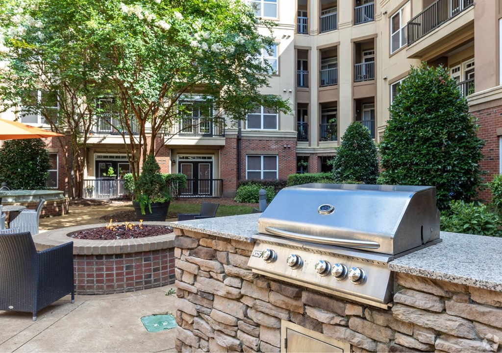 A stone wall with a grill on top of it.