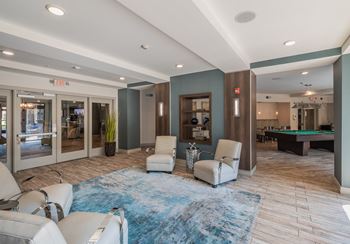 A spacious room with a pool table and comfortable seating.