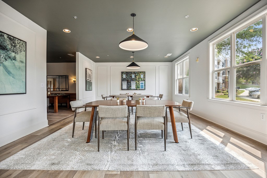 A modern co-working space with a large table and chairs.