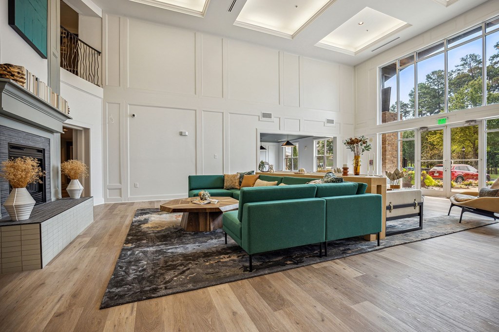 A living room with a green couch and a fireplace.