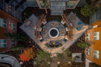 A courtyard surrounded by buildings with a circular design in the middle.