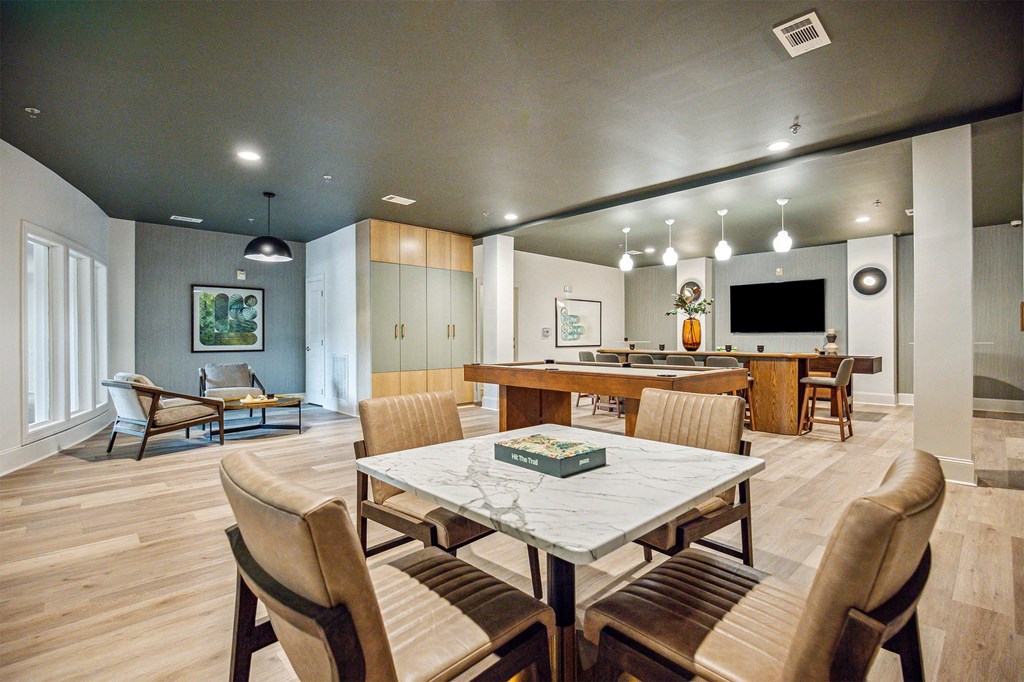 A modern dining room with a large table and chairs.
