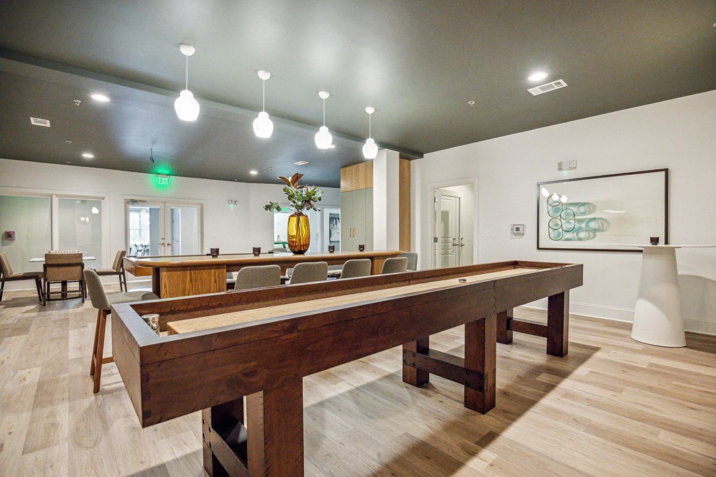 A room with a long table and chairs.