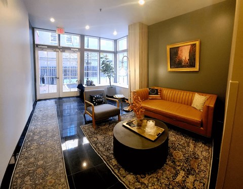 A living room with a couch, chair, and coffee table.