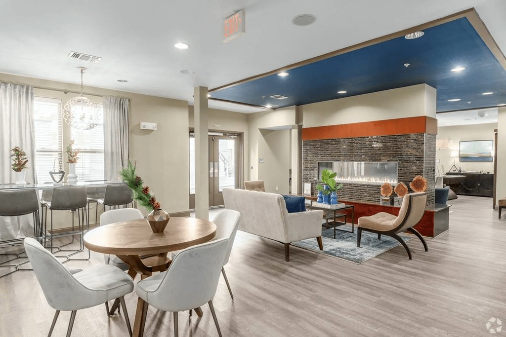 A modern dining room with a wooden table and chairs.