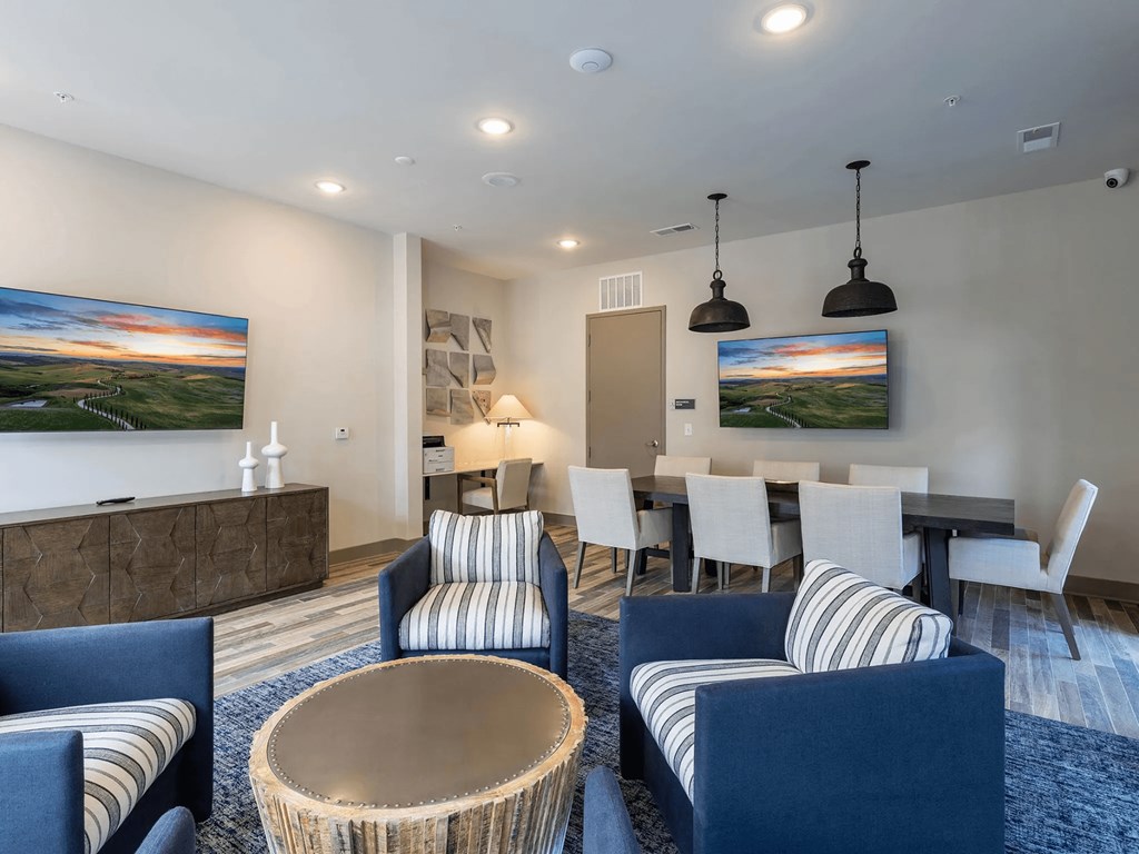 A modern living room with a dining table and chairs.