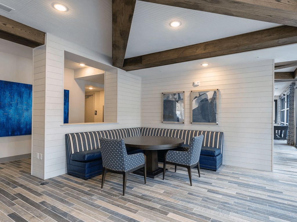 A dining area with a round table and chairs.