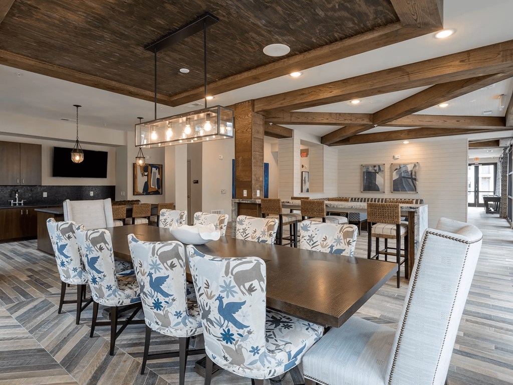 A large dining room with a long table surrounded by chairs.