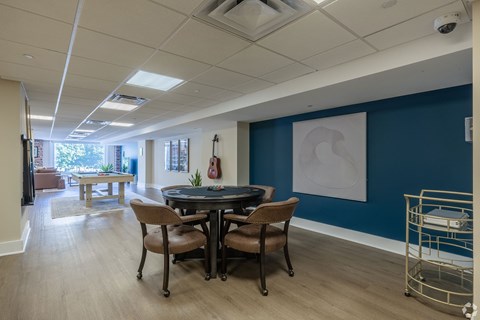 A conference room with a table and chairs.