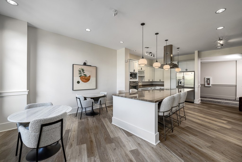 A modern kitchen with a dining table and chairs.
