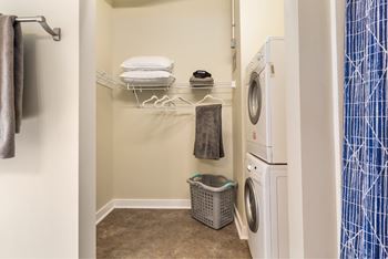 A small laundry room with a washer and dryer.