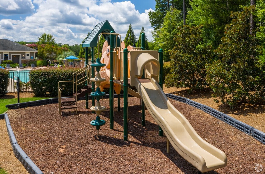 A playground with a slide and a climbing structure.