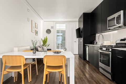 A modern kitchen with a dining table and chairs.