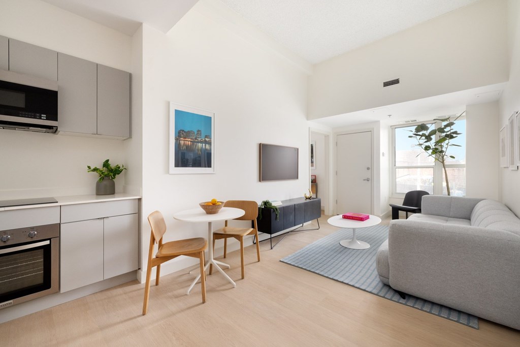 A modern kitchen with a dining table and chairs.