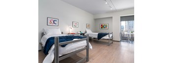 two beds in a room with a city view