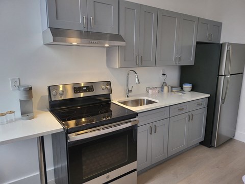 a kitchen with stainless steel appliances and white cabinets