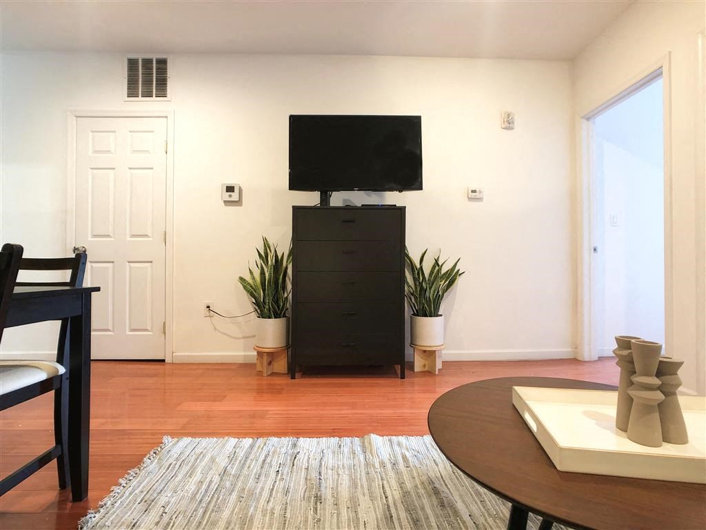 a living room with a tv on top of a dresser
