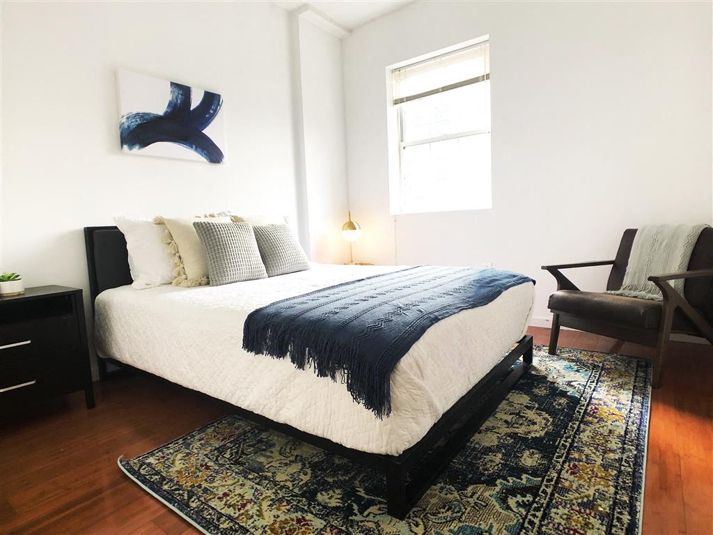 a bedroom with a bed and a window