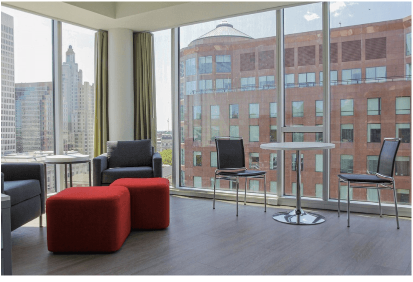 a living room with chairs and a table and a large window