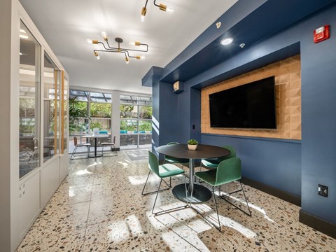 A dining area with a table and chairs.