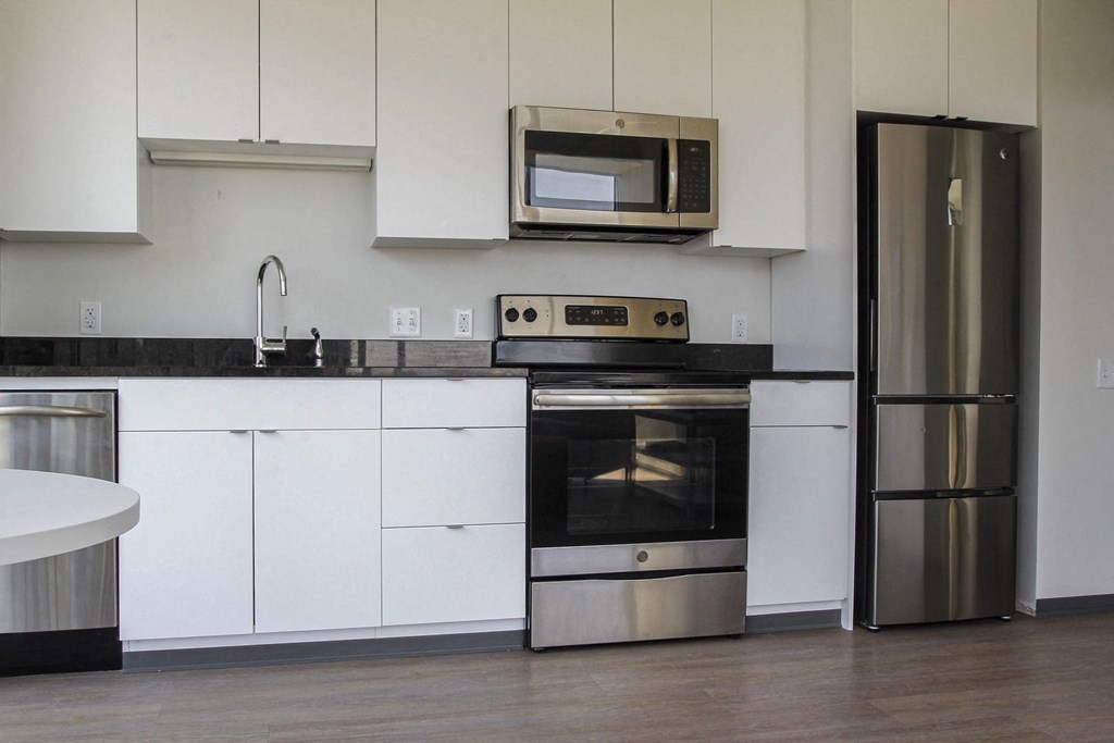 a kitchen with stainless steel appliances and white cabinets