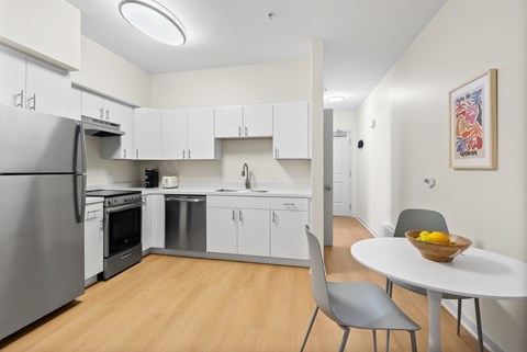 A modern kitchen with a table and chairs.