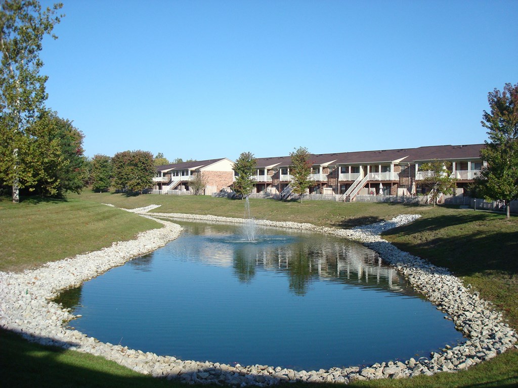 a pond with a building in the background