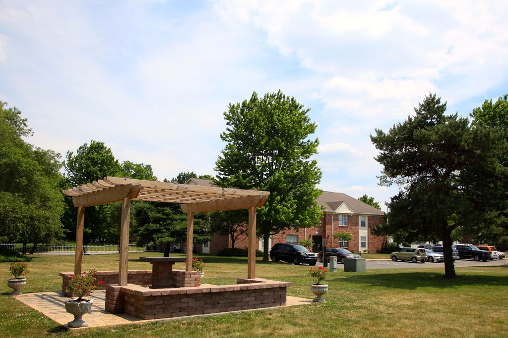 a park with a pavilion and a fire pit
