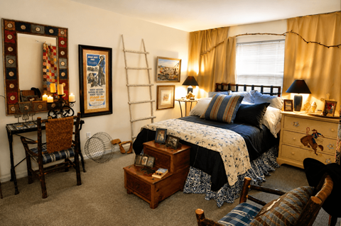 A bedroom with a bed, dresser, and chair.