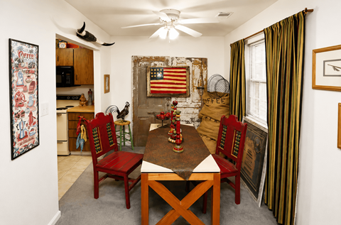 A dining room with a wooden table and chairs.