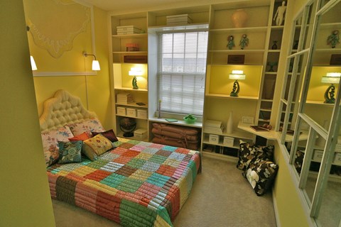 a bedroom with a bed in a closet