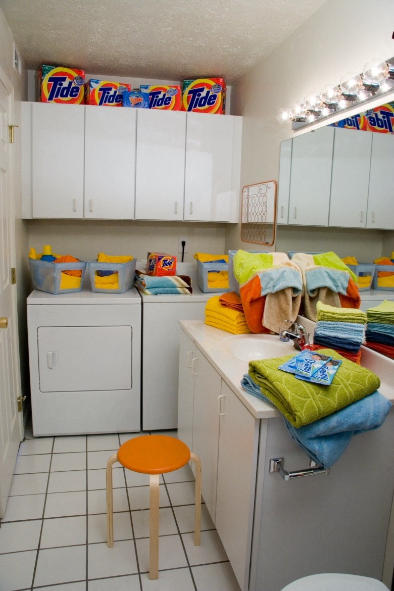 a laundry room with washing machines and towels on the counter