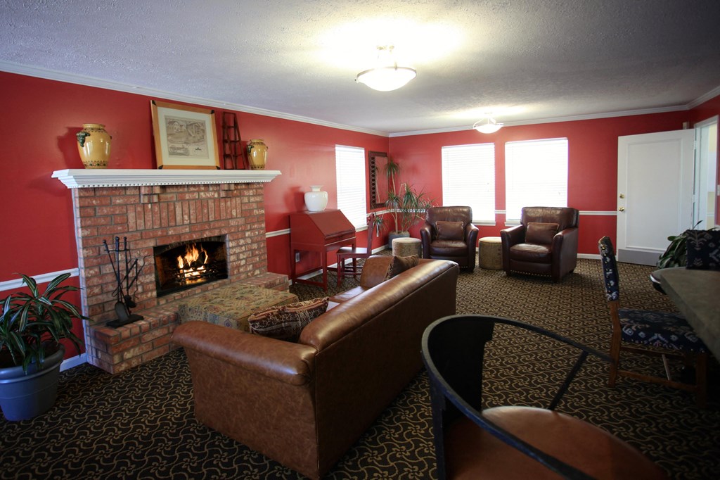 a living room with red walls and a fireplace
