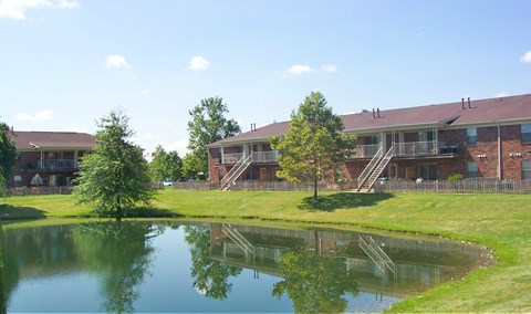 a view of a building with a pond in front of it