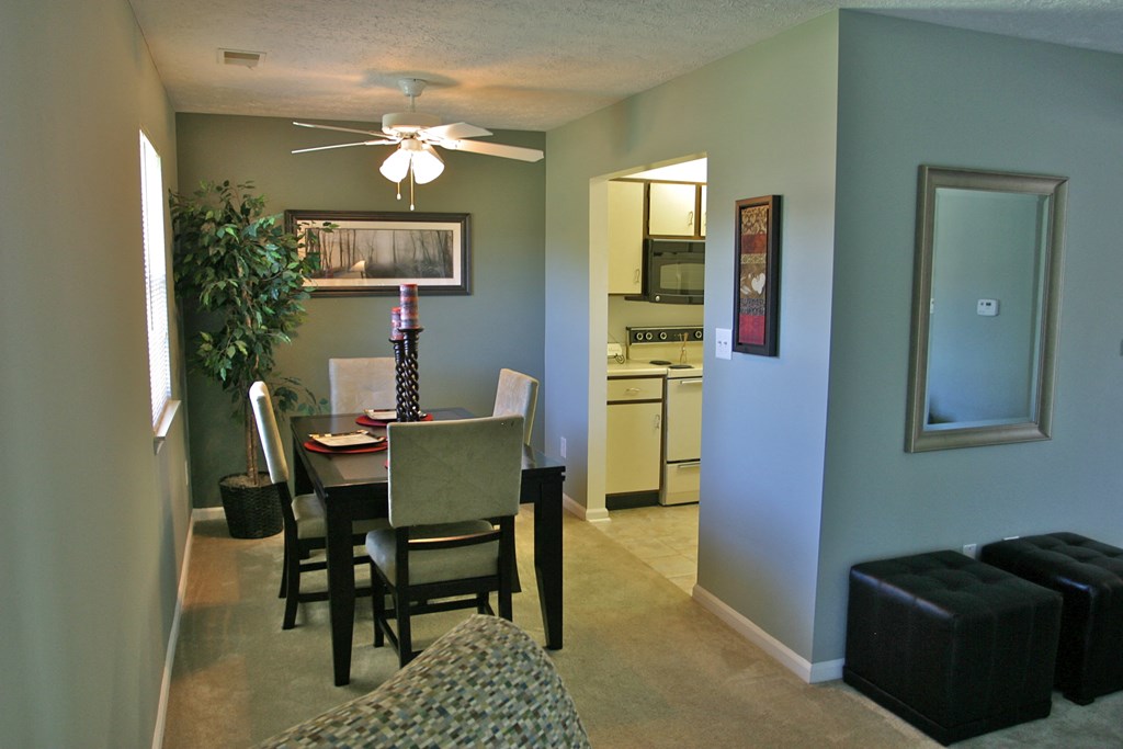 a living room with a dining room table and a kitchen