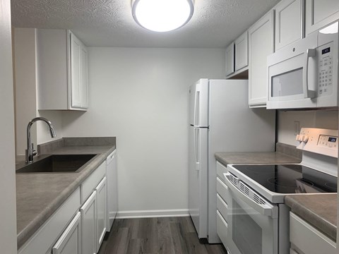 a kitchen with stainless steel appliances and white cabinets