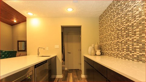 a kitchen with a sink and a door to a hallway