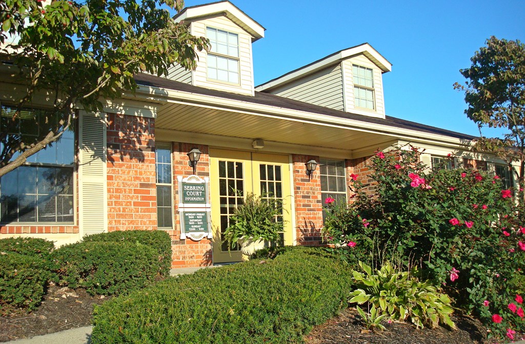 the front of a house with a sign in the window