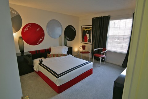 a bedroom with a bed and balloons on the wall