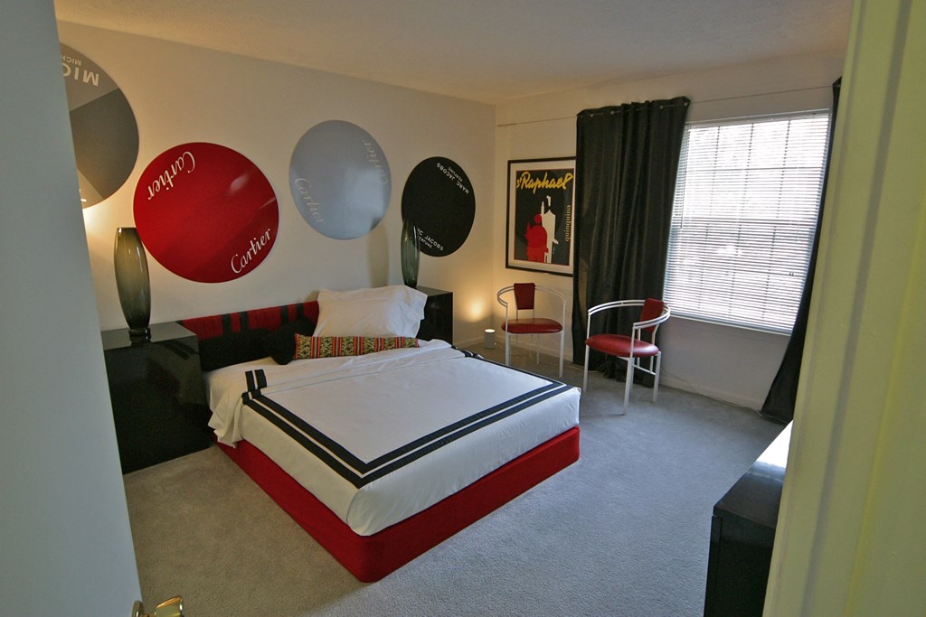 a bedroom with a bed and balloons on the wall