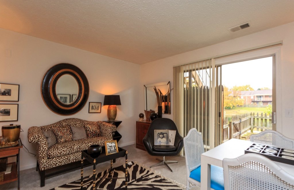 a living room with a couch and a table and a sliding glass door
