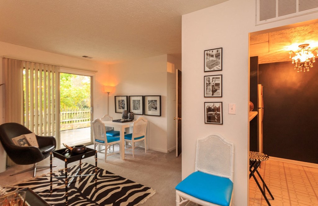 a living room and dining room with a zebra rug and a table and chairs
