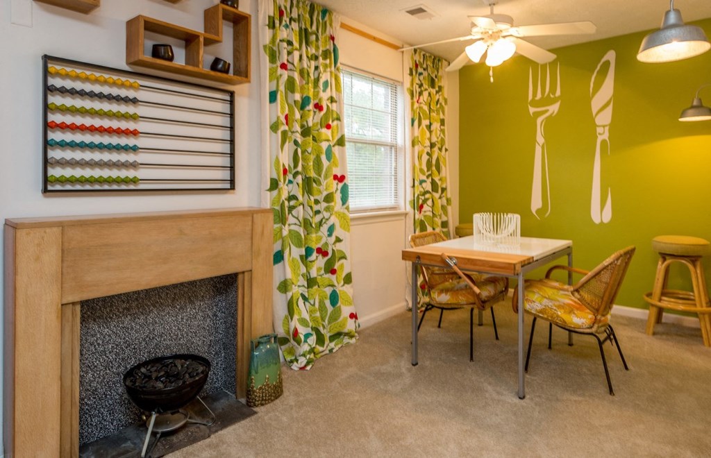 a dining room with a table and chairs and a fireplace