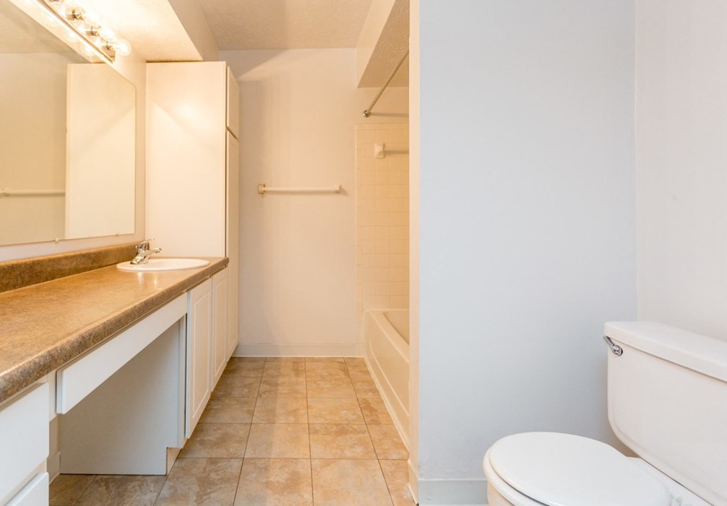 a bathroom with a toilet and a sink and a shower
